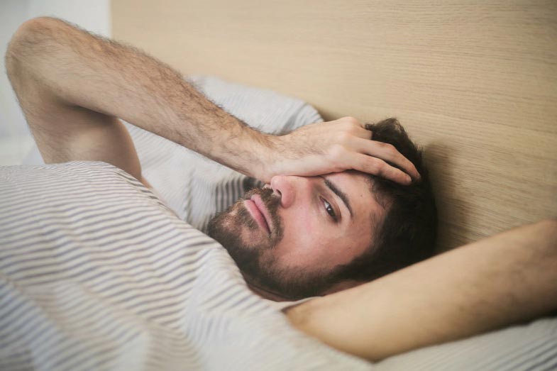 Tired Man Lying Awake in Bed