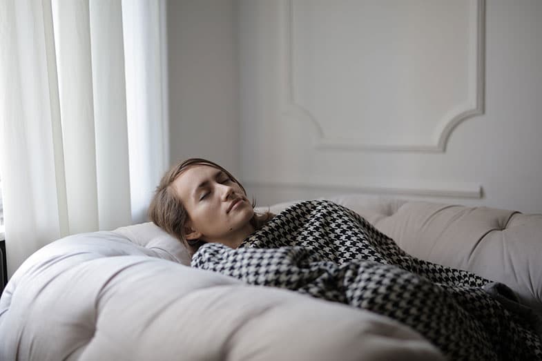 Woman Sleeping on the Couch With a Blanket