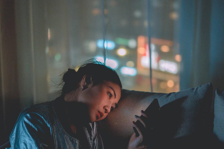 Woman Using Mobile Phone at Night