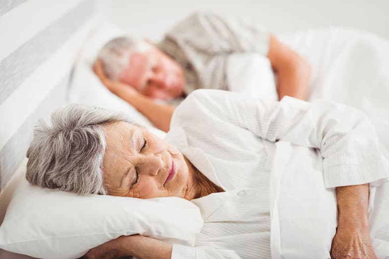Senior Couple Sleeping on a Bed