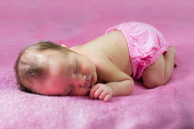 Newborn Baby Sleeping with their Bum in the Air