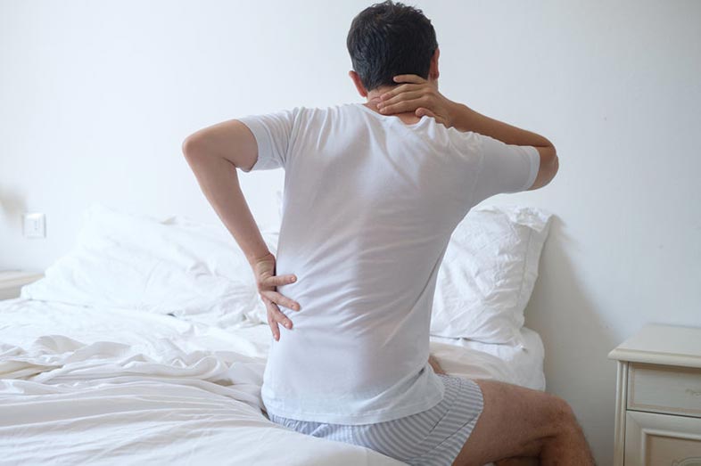 Man With Back Pain in Bed After Sleeping